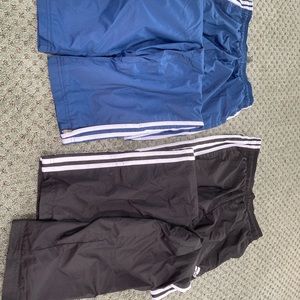 2 pairs of men’s Adidas wind pants. Blue pair missing drawstrings. Size: small